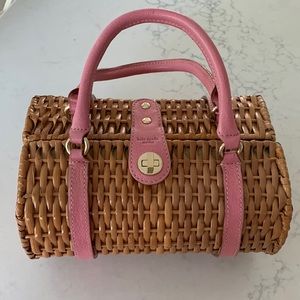 Vintage Kate Spade wicker handbag with pink leather accents and handles.